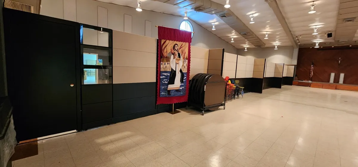 Sections of an 85-foot full-height modular wall staged for installation